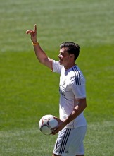 Gareth Bale of Wales gestures to fans during his presentation at the Santiago Bernabeu stadium in Madrid